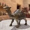 Artistic Camel Ashtray with Antique Finish and Intricate Carvings on a White Table