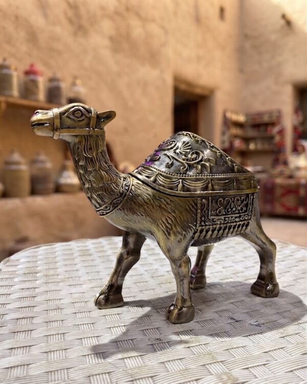 Artistic Camel Ashtray with Antique Finish and Intricate Carvings on a White Table
